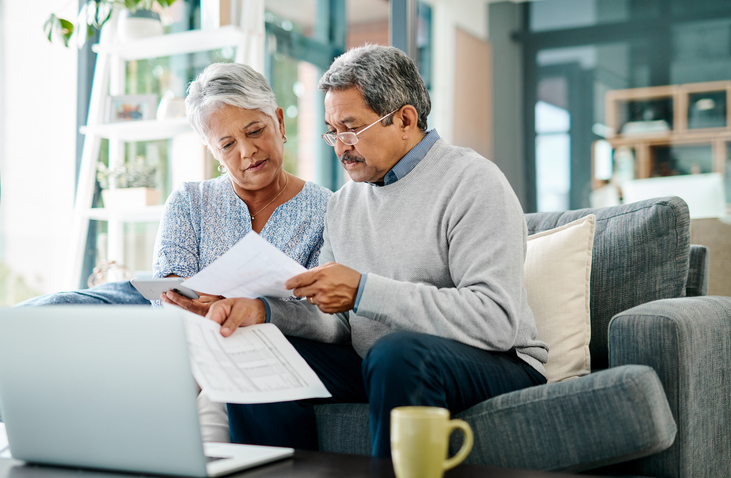 A senior couple reviewing their finances.